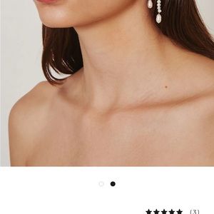 White freshwater pearls cascade from a center pearl